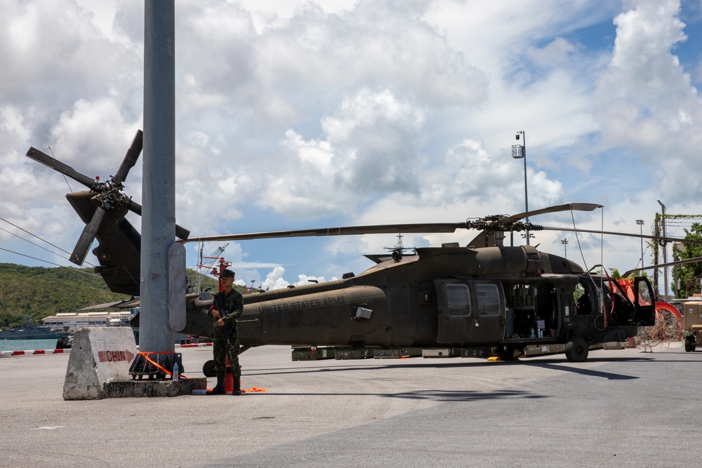 A Royal Thai Army Soldier stands guard over a U.S. Army UH-60 Black Hawk