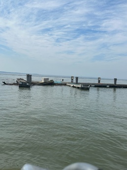 Coast Guard boat crew from Station New London, Connecticut, take photos of a dock that has broken from its mooring.