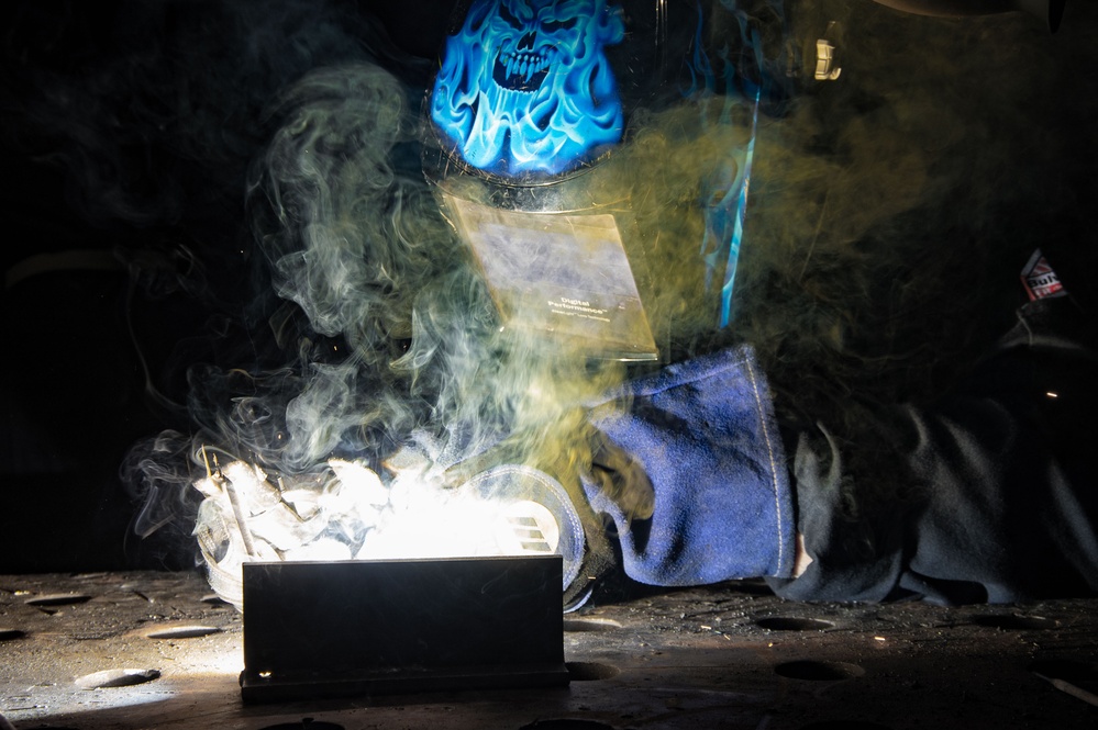 USS Ronald Reagan (CVN 76) Sailors train midshipmen how to weld and use a lathe