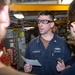 USS Ronald Reagan (CVN 76) Sailors train midshipmen how to weld and use a lathe