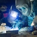 USS Ronald Reagan (CVN 76) Sailors train midshipmen how to weld and use a lathe