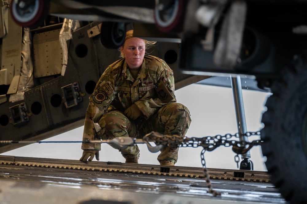 Yokota AB, Travis AFB Airmen load cargo onto C-17 Globemaster III in support of MG23