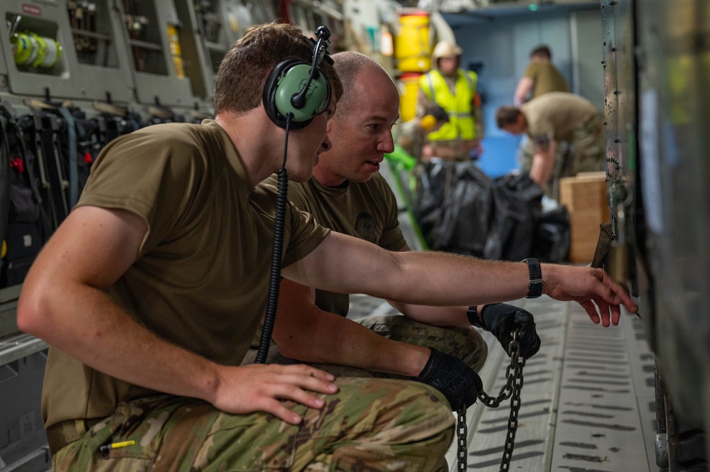 Yokota AB, Travis AFB Airmen load cargo onto C-17 Globemaster III in support of MG23