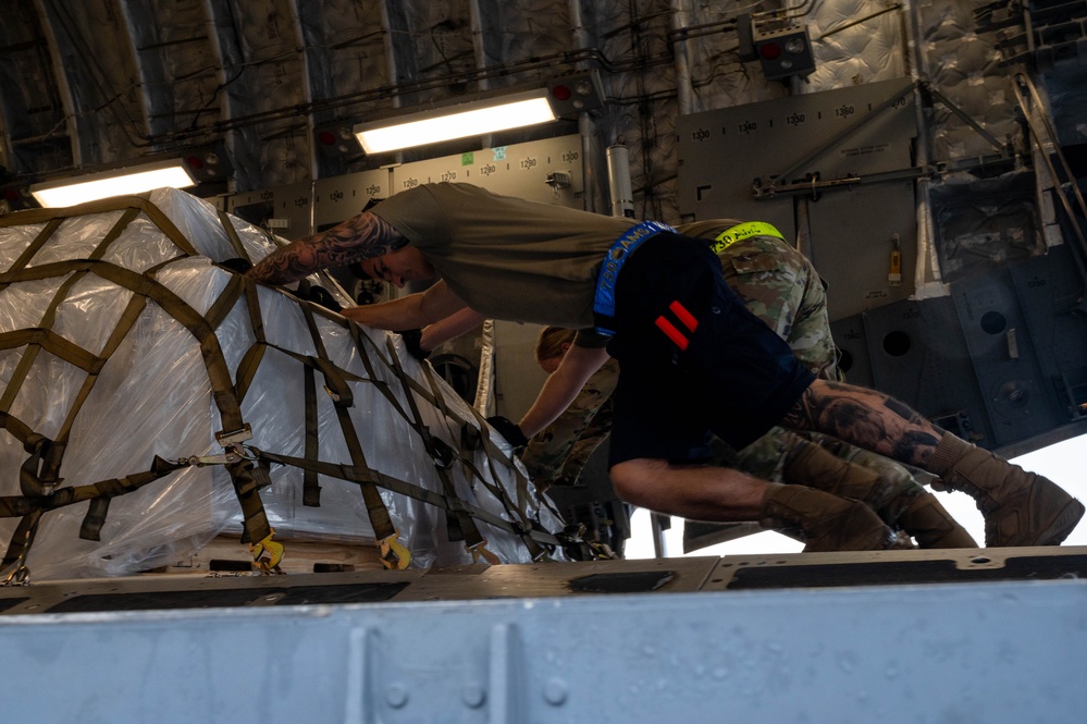 Yokota AB, Travis AFB Airmen load cargo onto C-17 Globemaster III in support of MG23