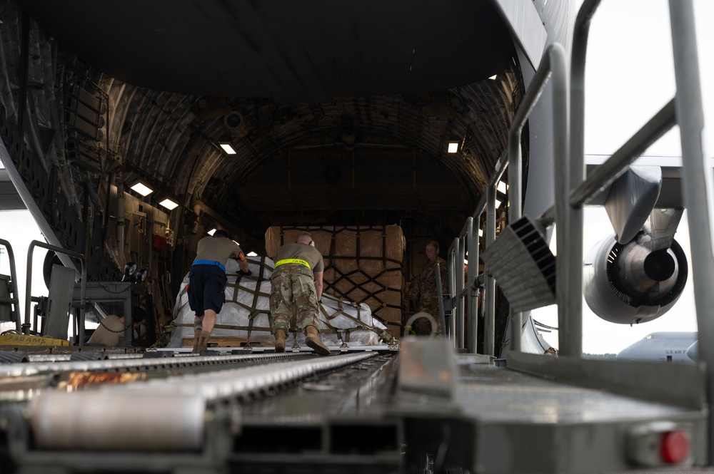 Yokota AB, Travis AFB Airmen load cargo onto C-17 Globemaster III in support of MG23