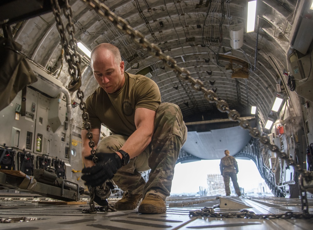 Yokota AB, Travis AFB Airmen load cargo onto C-17 Globemaster III in support of MG23