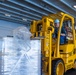 Sailors Move Supplies in the Hangar Bay of USS Carl Vinson (CVN 70)