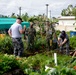 Service members from multiple nations volunteer together during an international community outreach event