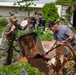 Service members from multiple nations volunteer together during an international community outreach project on Guam