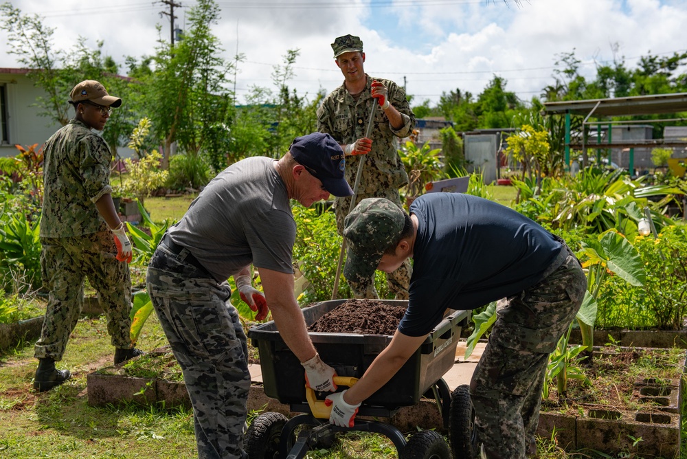 Sailors from four different national navies work together to complete a volunteer project on Guam