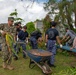 Service members from multiple navies work together during an international community relations project on Guam