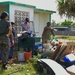 A representative of Island Girl Power directs international volunteers through typhoon debris mitigation