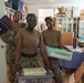 U.S. Navy Sailors pose during a community outreach project at Island Girl Power on Guam