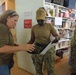 Staff at Island Girl Power provide direction to volunteer sailors during a community outreach project