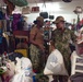 Volunteer Sailors help organize the thrift shop at Island Girl Power