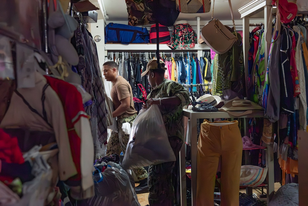 Sailors help organize Island Girl Power's Thrift Shop