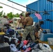 Sailors sort through typhoon-damaged goods during a volunteer project at Island Girl Power