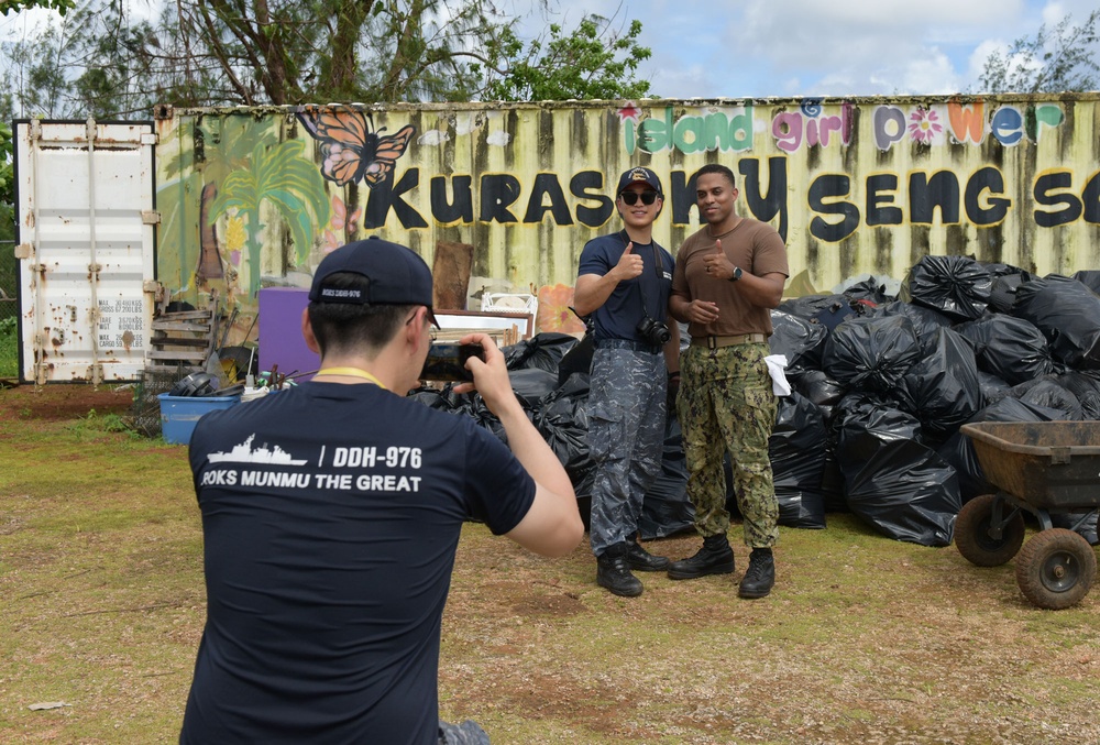 Sailors from the Republic of Korea Navy take a photo with U.S. Navy sailors during a volunteer project