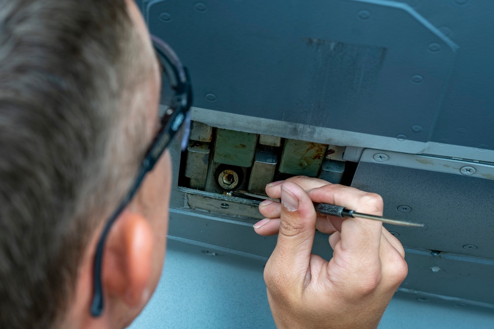 901 SOAMXS airmen carry out routine maintenance on MC-130J