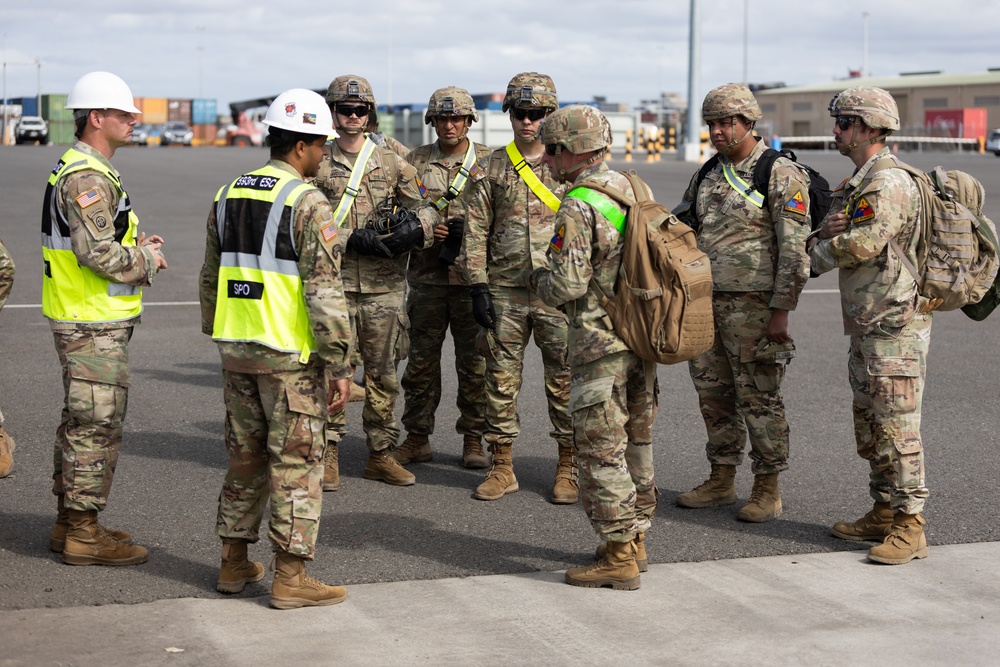 Chief Warrant Officer 2 John Young briefs Soldiers at the Port of Gladstone, Australia.