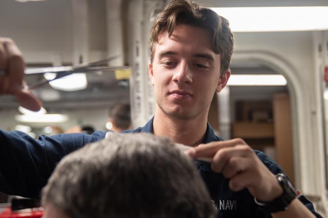 USS Ronald Reagan (CVN 76) Sailors get haircuts