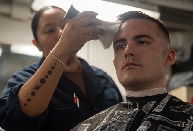 USS Ronald Reagan (CVN 76) Sailors get haircuts