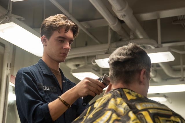 USS Ronald Reagan (CVN 76) Sailors get haircuts