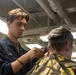 USS Ronald Reagan (CVN 76) Sailors get haircuts