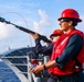 USS Robert Smalls (CG 62) Sailor Shoots Shot Line during RAS