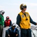 USS Robert Smalls (CG 62) Sailor Signals Pilot during Flight Quarters