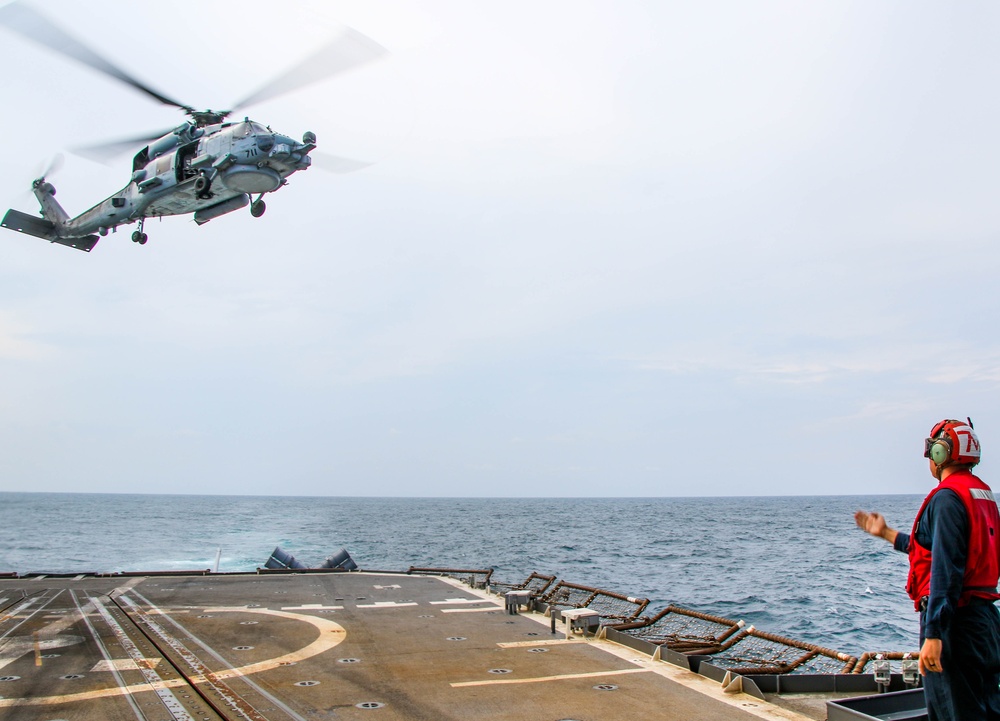 USS Robert Smalls (CG 62) Sailor Signals Pilot during Flight Quarters