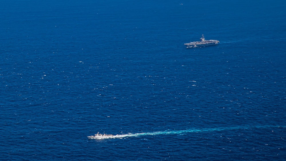 USS Ronald Reagan (CVN 76) steams in formation with Indonesian navy ships KRI Sultan Hasanuddin (366) and KRI Sultan Iskandar Muda (367)