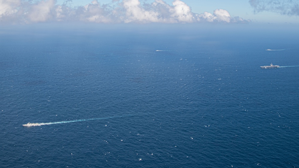 USS Ronald Reagan (CVN 76) steams in formation with Indonesian navy ships KRI Sultan Hasanuddin (366) and KRI Sultan Iskandar Muda (367)