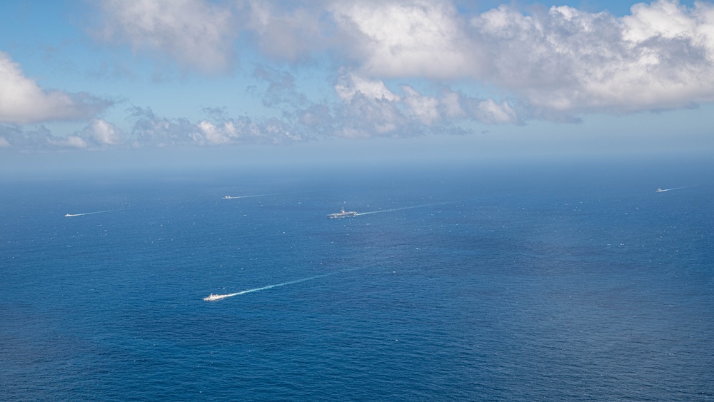 USS Ronald Reagan (CVN 76) steams in formation with Indonesian navy ships KRI Sultan Hasanuddin (366) and KRI Sultan Iskandar Muda (367)