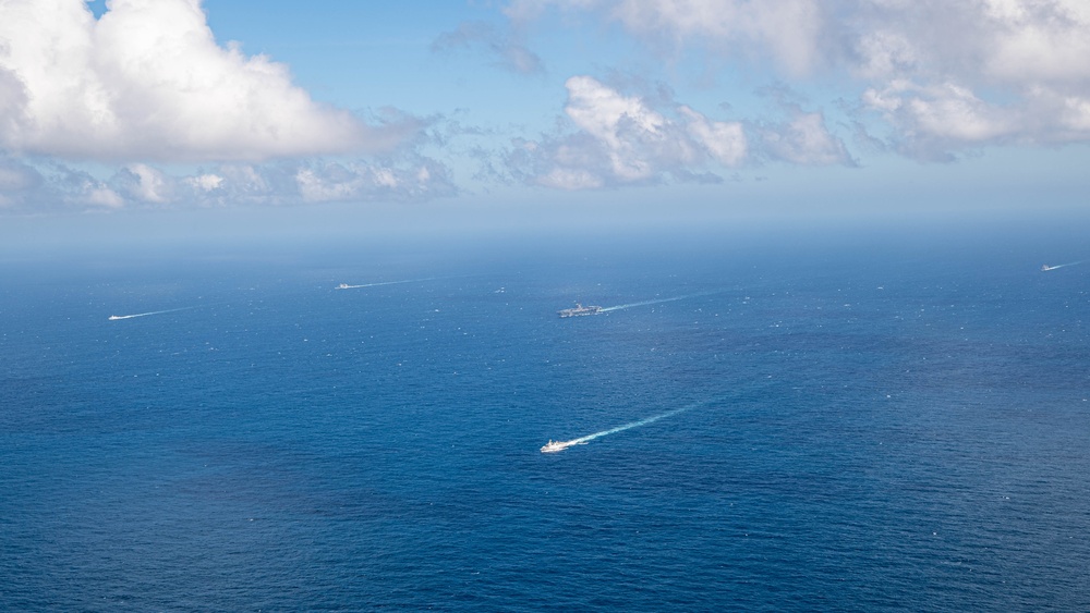 USS Ronald Reagan (CVN 76) steams in formation with Indonesian navy ships KRI Sultan Hasanuddin (366) and KRI Sultan Iskandar Muda (367)