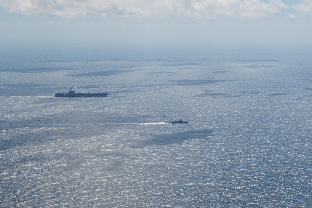 USS Ronald Reagan (CVN 76) steams in formation with Indonesian navy ships KRI Sultan Hasanuddin (366) and KRI Sultan Iskandar Muda (367)