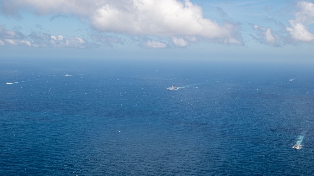 USS Ronald Reagan (CVN 76) steams in formation with Indonesian navy ships KRI Sultan Hasanuddin (366) and KRI Sultan Iskandar Muda (367)