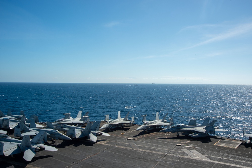 USS Ronald Reagan (CVN 76) steams in formation with Indonesian navy ships KRI Sultan Hasanuddin (366) and KRI Sultan Iskandar Muda (367)