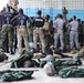 Military members from seven countries listen to a safety briefing ahead of Fast Rope Insertion and Extraction System (FRIES) training at Air Base London, Guyana, on July 17, 2023