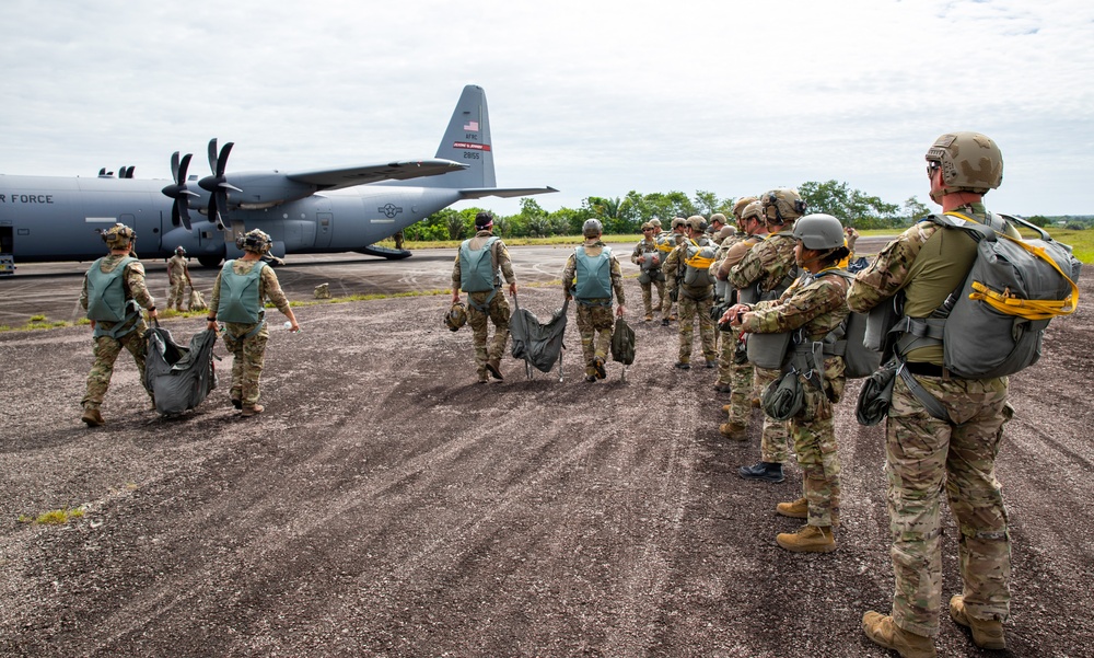 U.S. and Multinational Partners prepare parachutes to jump out of a C-130 during TRADEWINDS 2023