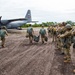 U.S. and Multinational Partners prepare parachutes to jump out of a C-130 during TRADEWINDS 2023