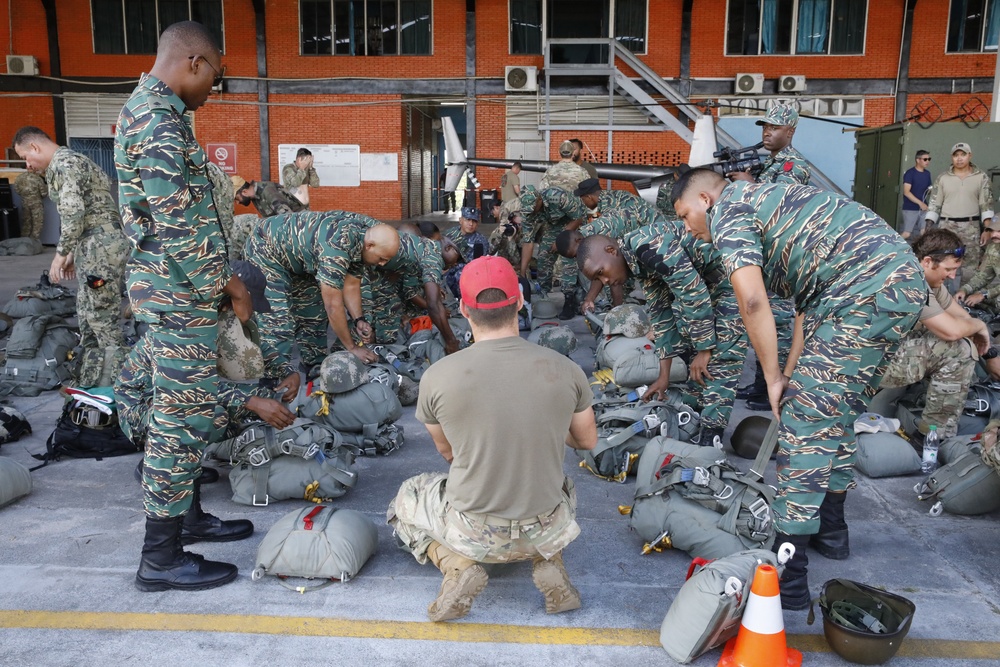 Service members of Belize, Mexico, Guyana, France, and U.S. train in airborne based operations.