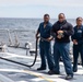 Crash and salvage team members train by fighting a simulated fire aboard USS Ralph Johnson.