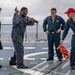 Crash and salvage team members train by fighting a simulated fire aboard USS Ralph Johnson.