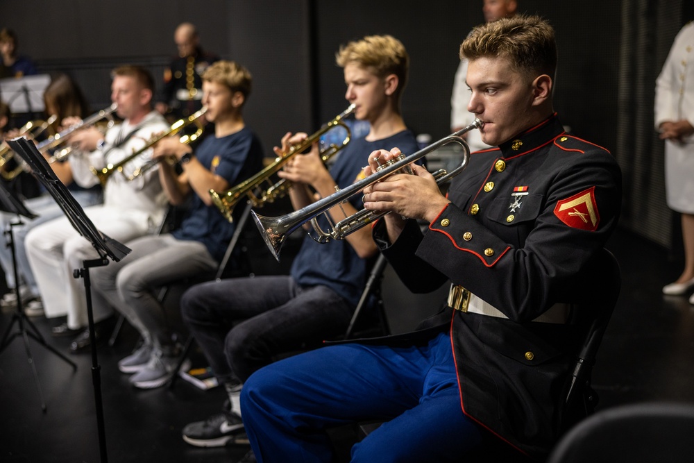 U.S. Marines and sailors with U.S. Naval Forces Europe and Africa perform at Vilkaviskis, Lithuania