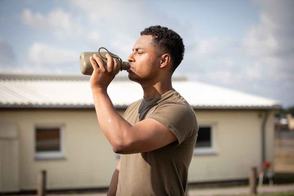 U.S. Army Soldier hydrating after Ruck March