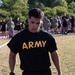 U.S. Army Soldier carries kettle bells in ACFT