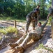 Army Staff Sgt. Emma Reos completes the low crawl wire obstacle