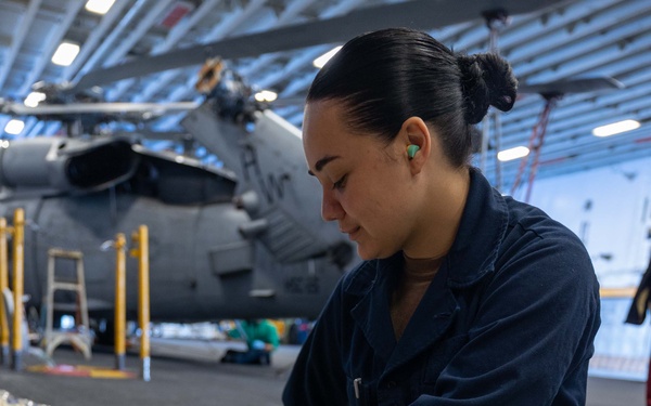 USS Bataan Sailor fills SCBAs