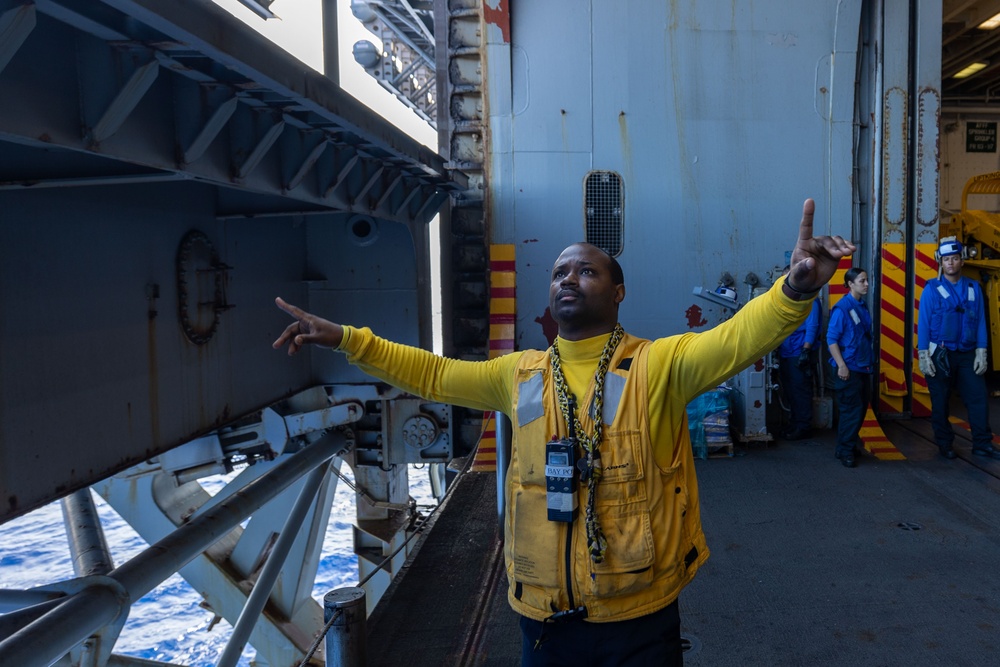 USS Bataan Sailors move an aircraft